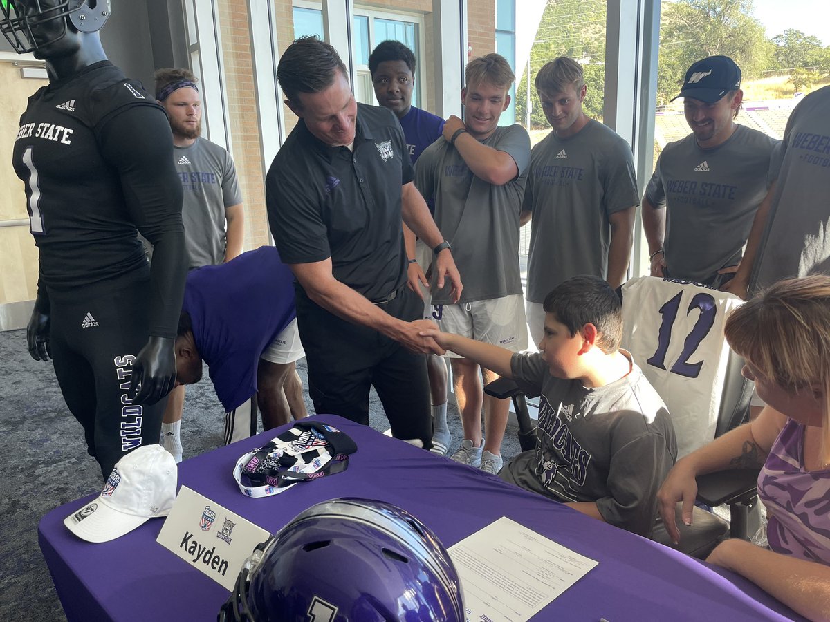 weberstate's tweet photo. New Wildcat! The @weberstatefb team signed 9-year old Kayden as part of @GoTeamIMPACT! 

#WeAreWeber https://t.co/iWnBbWkDPV