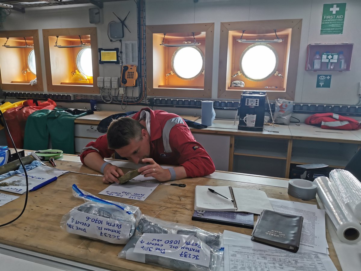 BritGeoSurvey's tweet photo. Gareth Carter, BGS Marine Geoscientist, taking preliminary notes of one of the rock samples acquired by ROV during the #JC237 Expedition to Whittard Canyon. BGS will be helping the team understand the geology & properties of the formations that underpin the slopes of the canyon. https://t.co/Z0CGjw2a0P