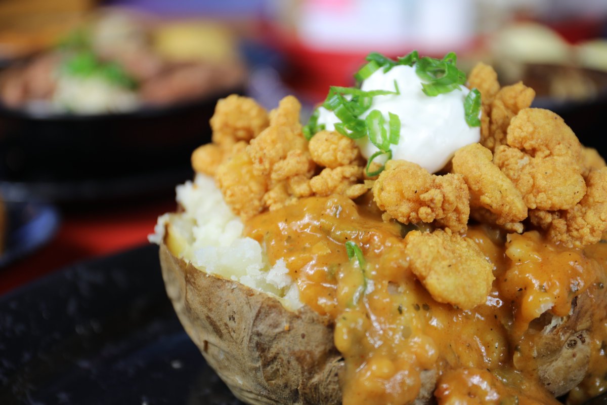 We whip each one pound baked potato with real butter. Add a little cheese, smother that with some delicious shrimp étouffée and top it with fried popcorn shrimp, a scoop of sour cream and a chives. #yum 📸 : House Baked Potato