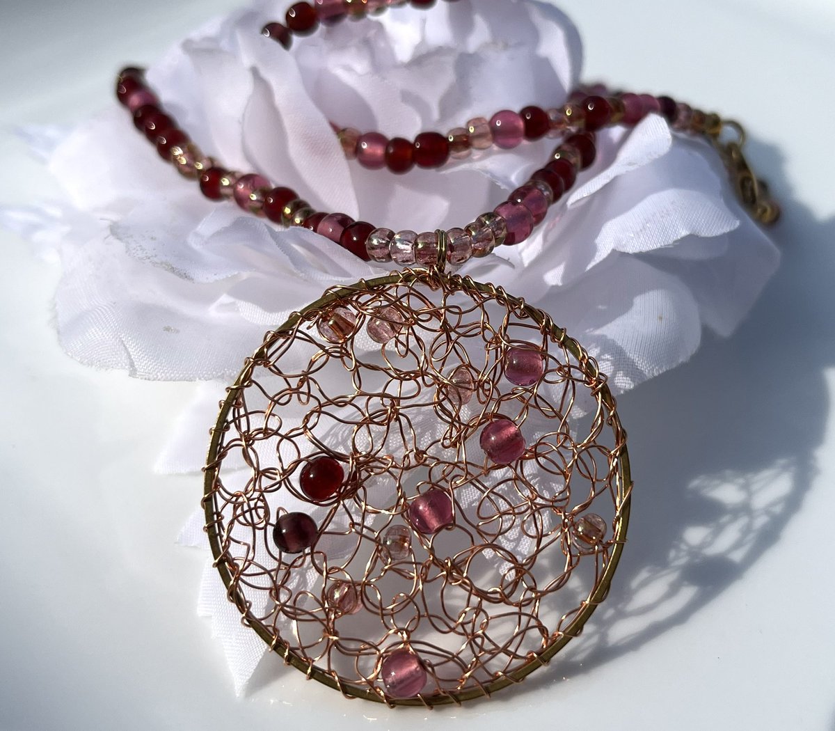 pearlysmith's tweet photo. Pink crocheted glass bead pendant https://t.co/SG33Jl8N42 #elevenseshour #mhhsbd #ukmakers #thecraftersuk #CraftBizParty https://t.co/B02ESTKAk3