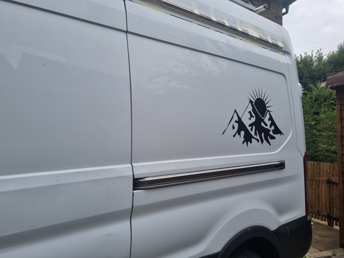 It's a white Ford Transit van with decals on the side with little mountains and a sun behind them. Give me a shout if you see it around lol