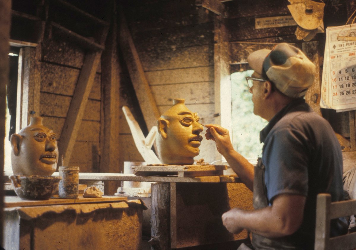 FoxfireOrg's tweet photo. Happy #FaceJugFriday! Renowned potter Lanier Meaders adds the finishing touches to some of his signature face jugs. Many of Lanier's relatives made #pottery in and around White County, GA, including his dad Cheever and mom Arie. https://t.co/9NofPmAamj
