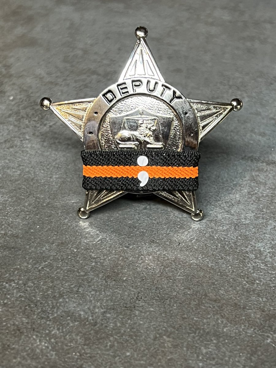 September is suicide prevention month. Deputy sheriff badge with Suicide prevention and awareness mourning band for law enforcement, firefighters. Emergency medical service and others to promote discussion in their agency and community. Mourningbands.org