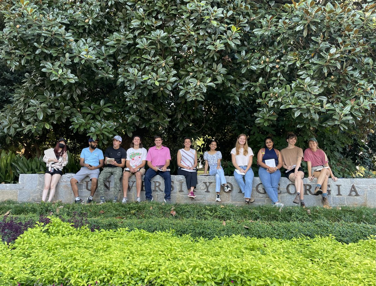UGACED's tweet photo. First year MLA students enrolled in Dr. Debra Mitchell's Plant Communities Class pause for a break in shade by the Jackson Street entrance to campus. #ugaced #landscapearchitecture #designeducation #environmentaldesign #mla #bla #landscapedesign #asla #gaasla https://t.co/rzm7aRTgOV