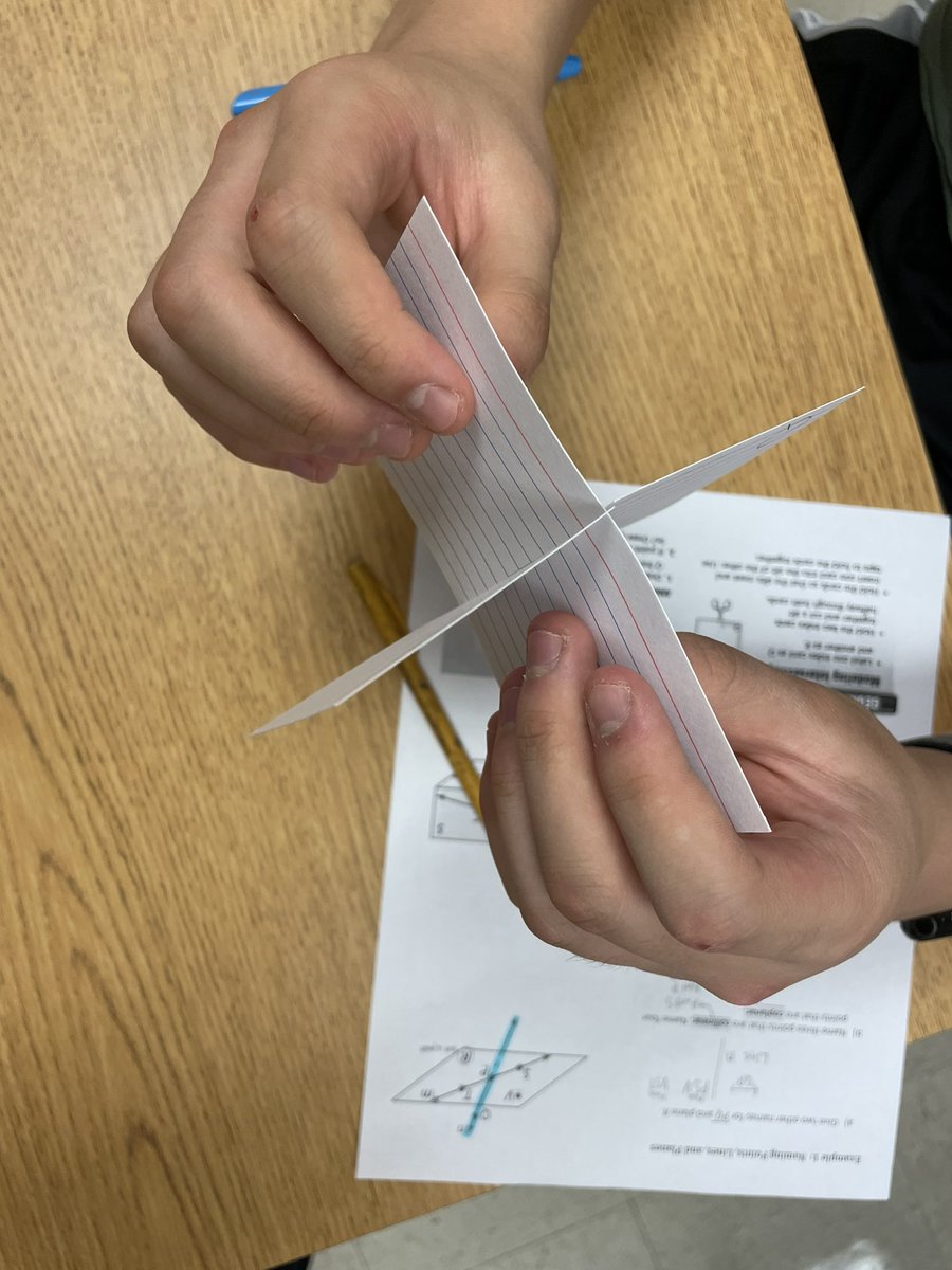 Students work together to model intersecting planes in Geometry! #ewlearns