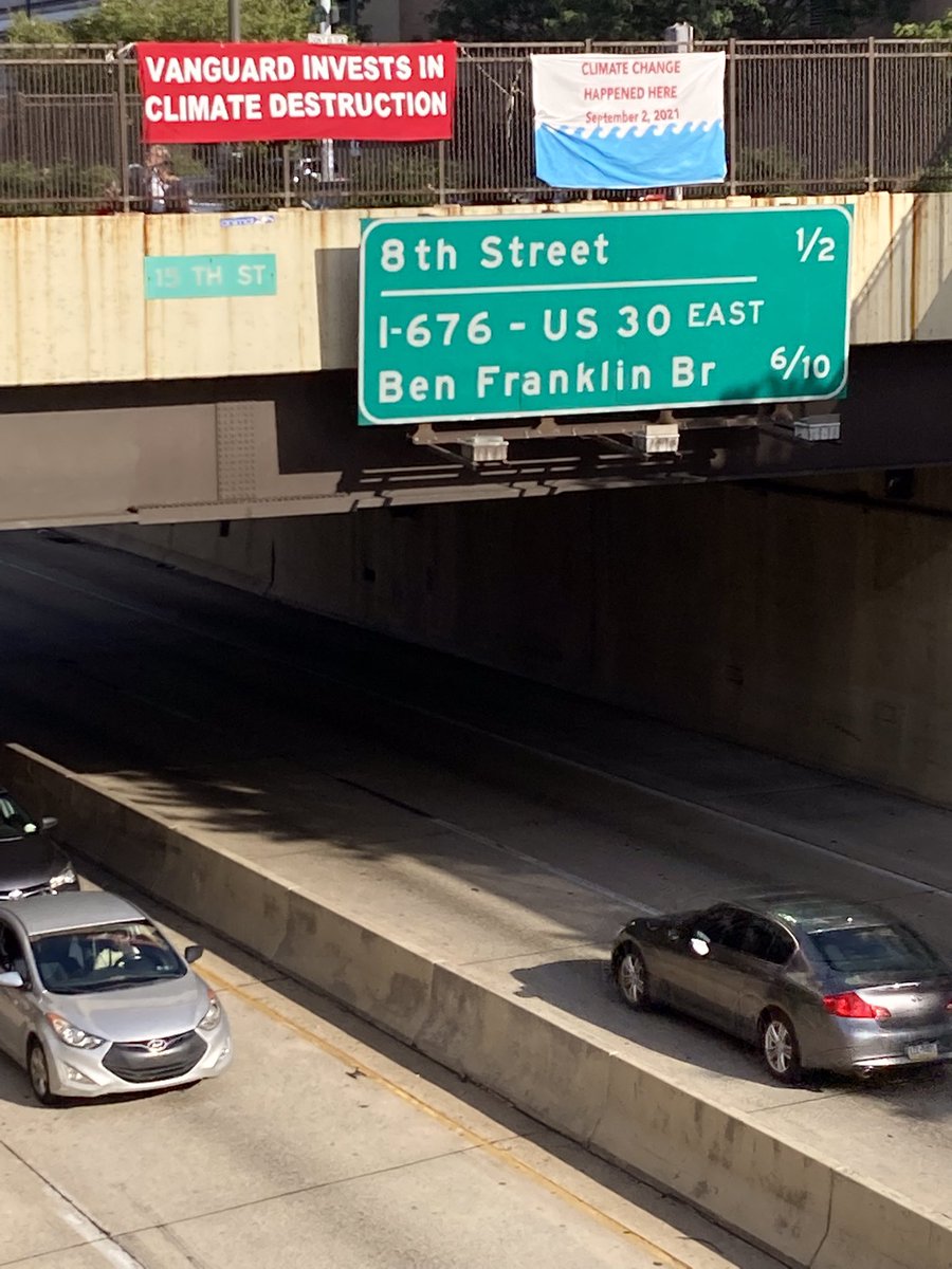 eqat's tweet image. Happening now: Friends from Central Philly Monthly Meeting hang banners over 676 connecting @Vanguard_Group’s investment in fossil fuels &amp;amp;  the climate disasters it’s complicit in if it doesn’t deal with its climate problem.