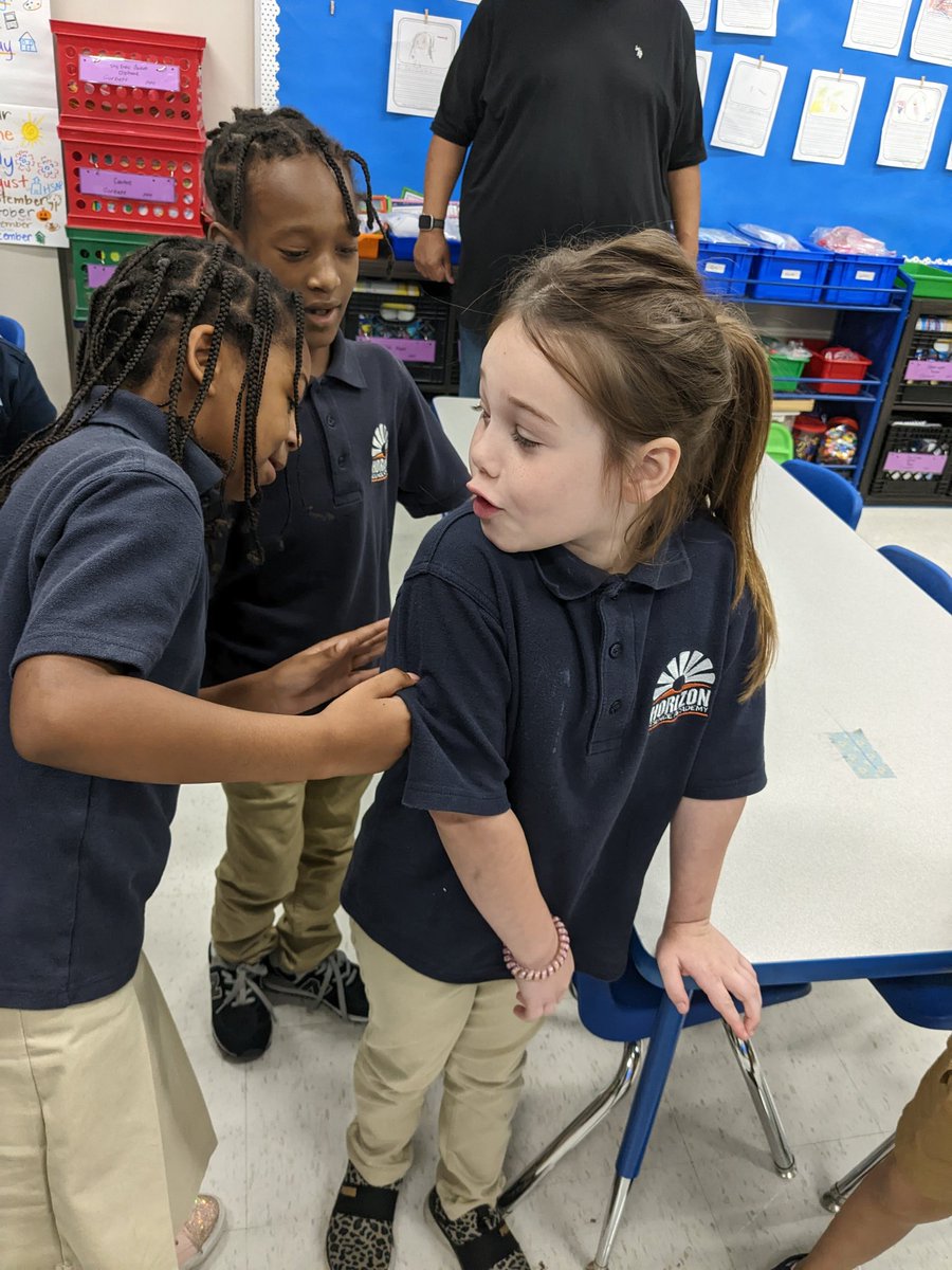 HSAColumbusPS's tweet photo. First graders had fun playing a guessing game today! Mrs. Corbett put community helpers on their back and then they practiced their speaking skills and questioning to figure out their community helper! #hsaprimary #weareconcept https://t.co/qvevRYl4jM