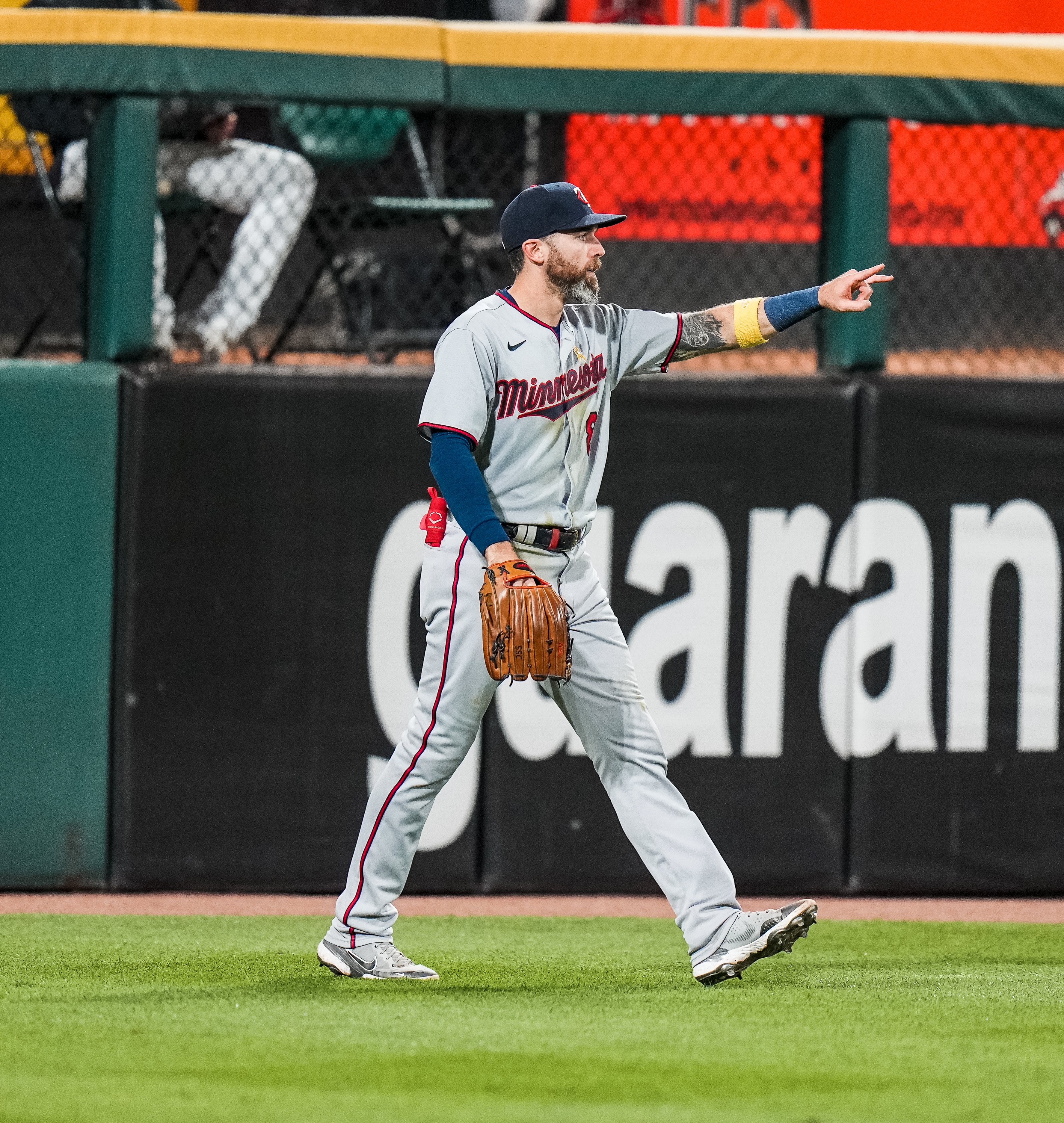Twins center fielder Jake Cave signals two outs after making an outfield assist in Chicago.