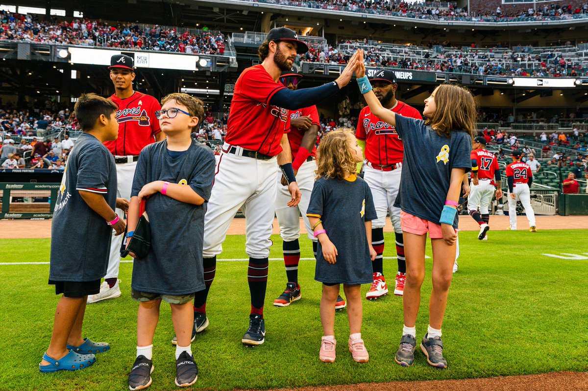Braves's tweet photo. In honor of Childhood Cancer Awareness Day at @TruistPark, we were honored to be joined on the field before tonight’s game by children who have beaten or are battling cancer 💛 https://t.co/jFLe0P71CI
