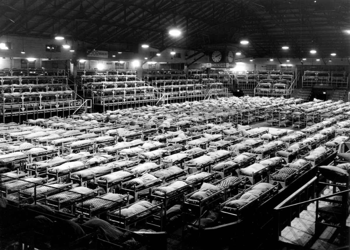 evelazarus's tweet photo. If you're at the PNE this weekend and wandering through the Forum, this was what it looked in 1942. It was called Men's Building K and held Japanese Canadians in deplorable conditions. Women and children were sent to the Livestock Building @vanarchives https://t.co/c4nFl7SlxH https://t.co/xfkdXXO2HL