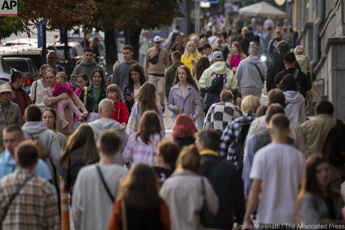 People walk in central Kyiv, Ukraine, Saturday, Sept. 3, 2022.
