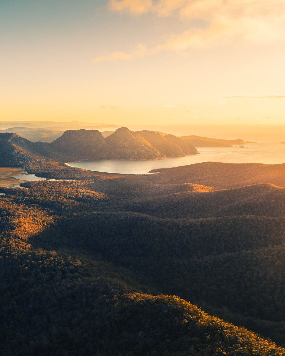 Golden morning light bouncing off Tasmania’s most famous wineglass...🌅 📍 Freycinet National Park, East Coast Tasmania  📷 IG\_benjaminfraser #DiscoverTasmania