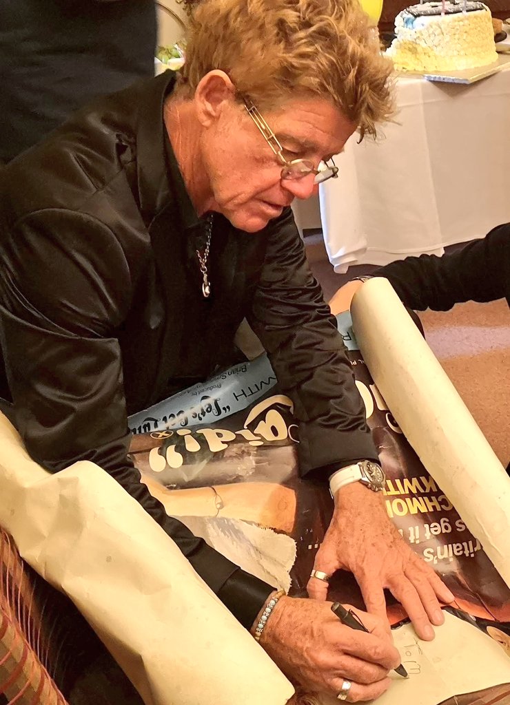 WightHot's tweet photo. @ConfessionsPete @Robin_Askwith @iwcponline Here is @Robin_Askwith signing the poster! Note the birthday cake in the background. He gave me his banana at breakfast - but that's another story... #LetsGetLaid https://t.co/r9Tul4ndYt
