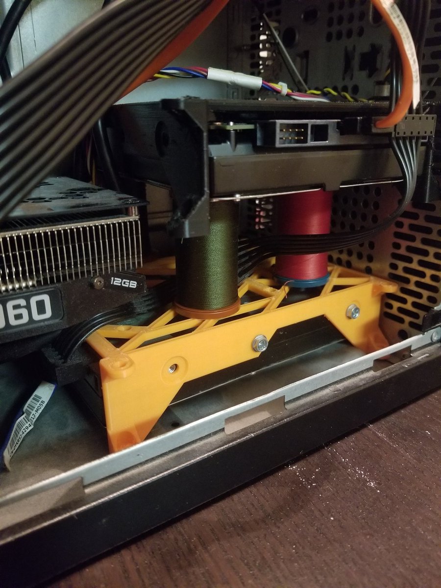 EmeritheC's tweet image. This is probably my worst idea yet. Support an unanchored hard drive with sewing spools. Fortunately, the wires provide a lot of tension, so I don&apos;t think the drive will move much when I have to tilt my case to keep the fan from whirring too loudly.