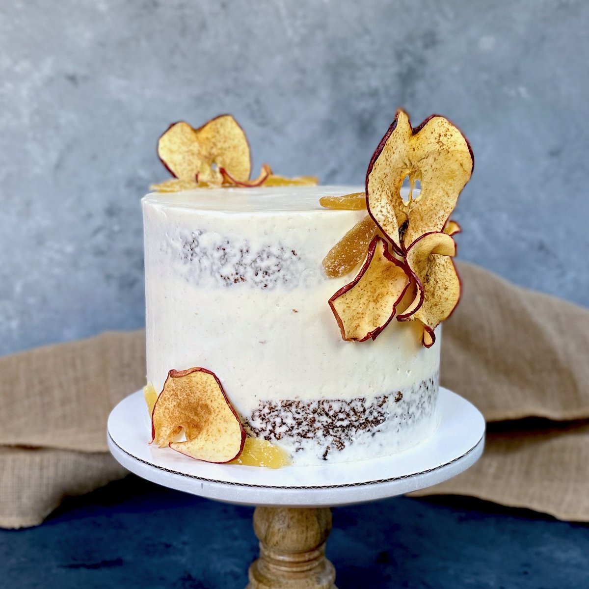 Apple ginger semi-naked cake! I’m fine-tuning my spice cake recipe. This version has more spice and moisture, like a light version of gingerbread. Ginger frosting, apple filling, and a separate optional bourbon glaze. 

Dried apple and candied ginger for garnish. 😋