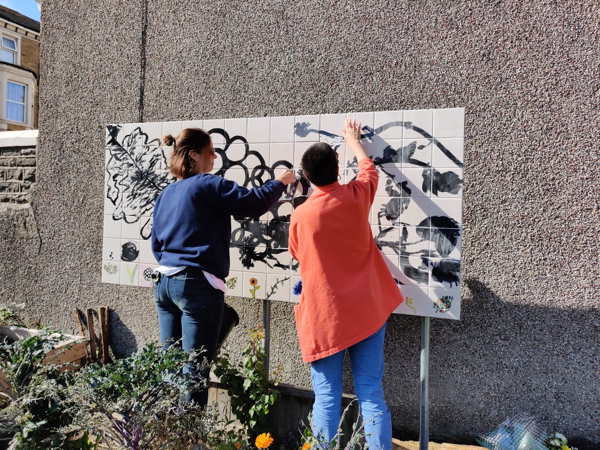 SaulArgent's tweet photo. Beautiful sunny day installing and revealing a new tile mural at Morecambe Community Micro Gardens with @GraftLancs & @goodthingscic, made by @BethShapeero with members of the community and local young people. https://t.co/9qMJTIKiQY