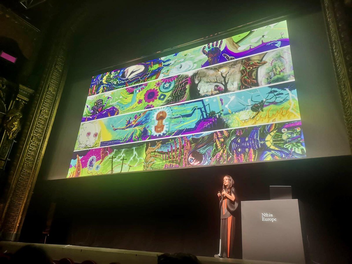 PowerDada's tweet photo. Dispatch from @nft_in_ in Paris! @eleonorabrizi talks about our Soul in the Machine visual conversation from 2019. One of our historic collections, it  also has a physical component, a box of mementos by the participating artists. So nice to see it up in lights! https://t.co/CltRFcqsZg