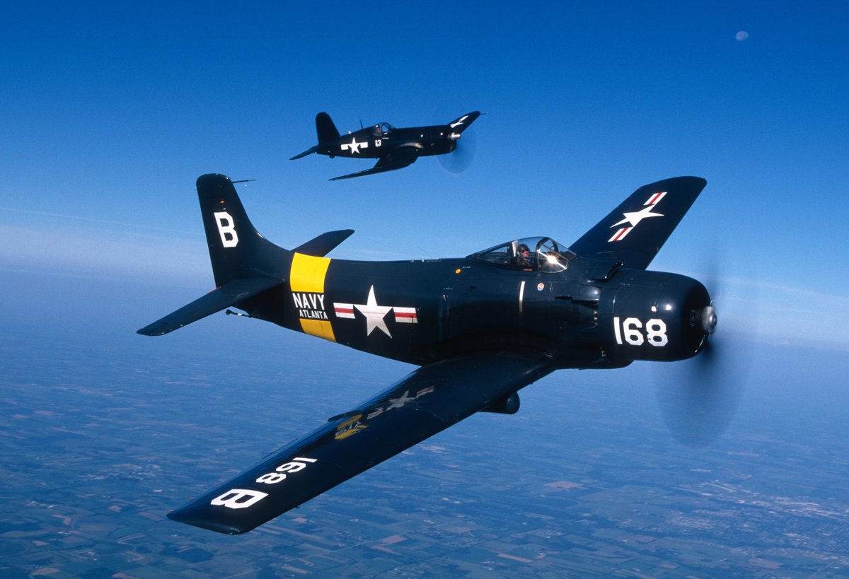 EAA's tweet photo. We're sending it back to EAA Oshkosh 1996 and this epic Skyraider/Corsair formation flight! What's your favorite @USNavy aircraft (past or present) that you've seen in person at Oshkosh? 📷 Jim Koepnick https://t.co/w8WCflWae3