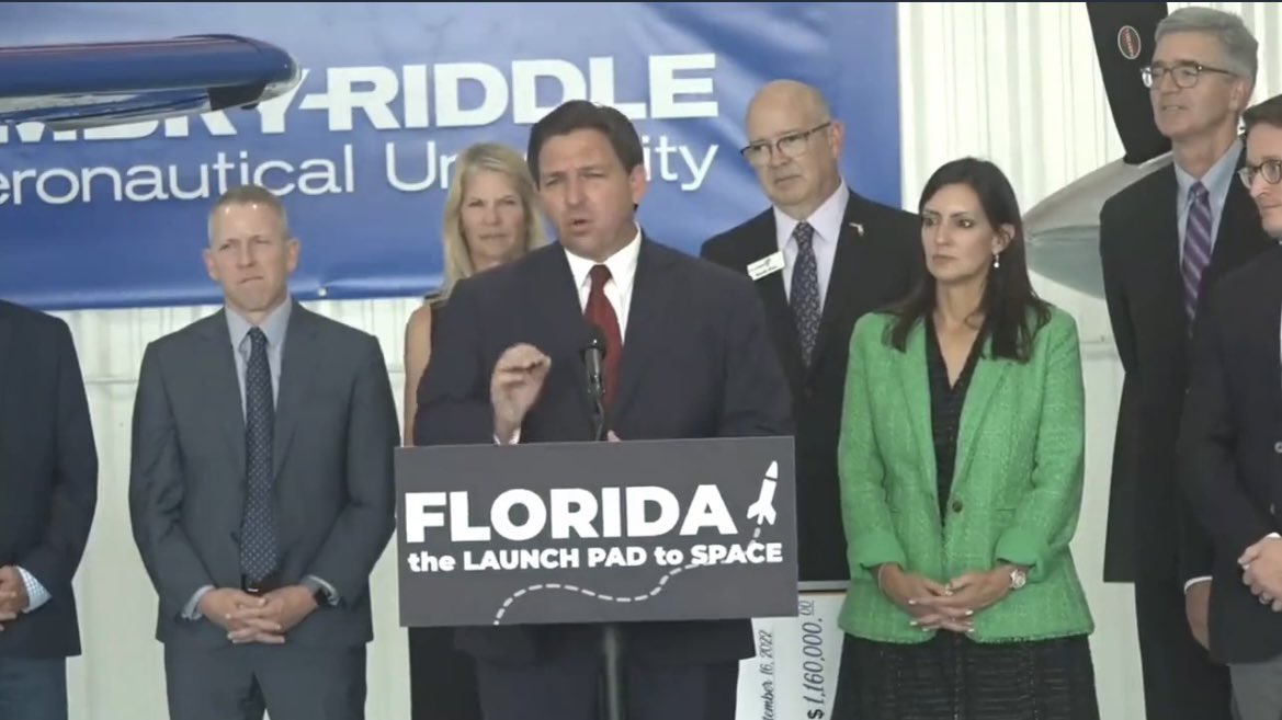 RonFilipkowski's tweet photo. How cute for officials of Embry-Riddle Aeronautical University to stand there with Ron Desantis and applaud while he gives a lengthy speech ripping Joe Biden’s immigration policy and other things. I didn’t realize it was a partisan political school. I thought it was aviation. https://t.co/8YoKGKvH3Q