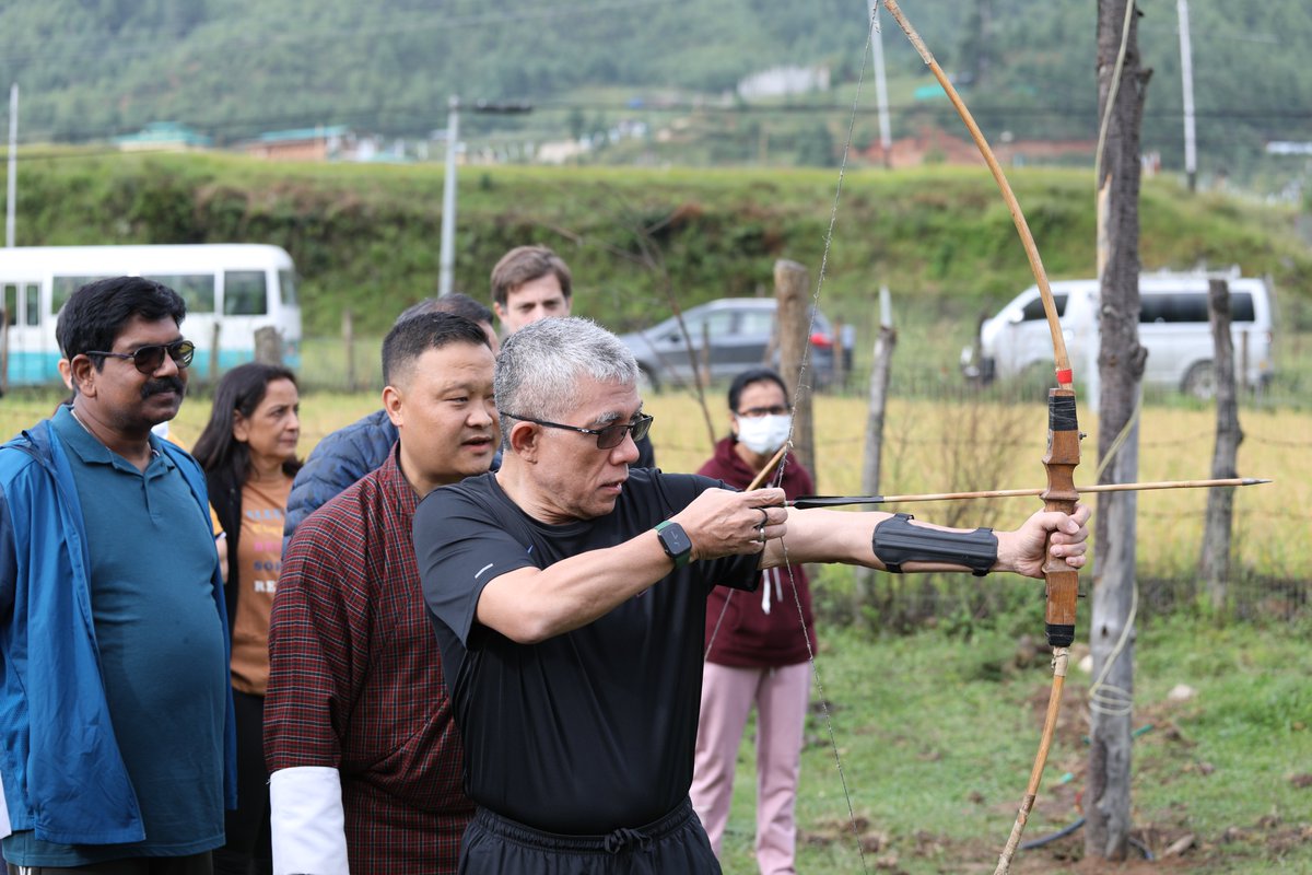 WHOSEARO's tweet photo. As part of daily morning exercise, Ministers of Health and delegates at #RC75 practiced traditional pastimes of khuru (darts), and archery, the national sport of #Bhutan. https://t.co/76zswshUg5