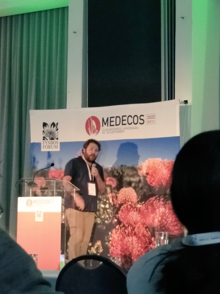 BAdriaanGrobler's tweet photo. Despite #Loadshedding, Day 3 of #fynbosMedecos2022 is underway:

@JacoLeRoux01 tells us about the effects of plant invasions on soil microbes during his keynote address. https://t.co/ge6RdnEV7b