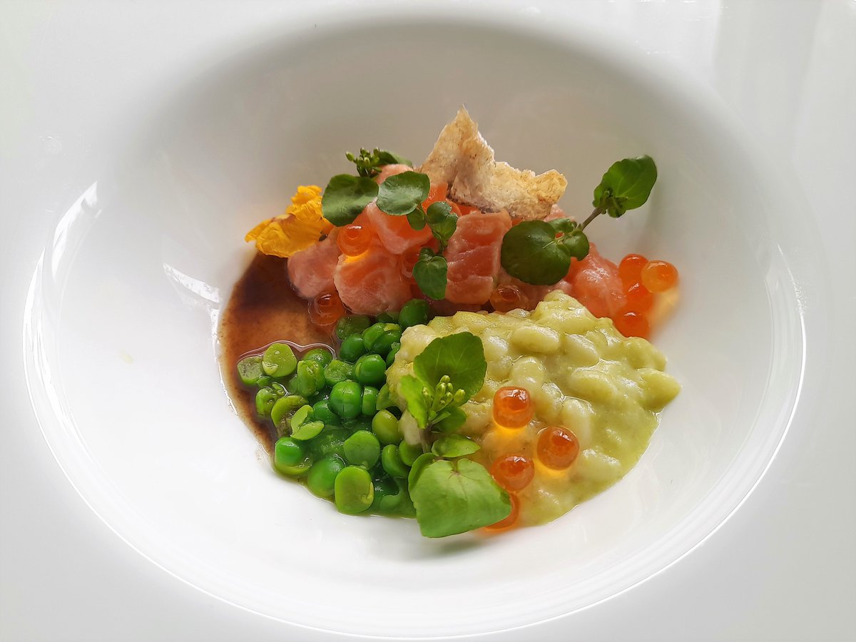 Herbs risotto with Parmigiano Reggiano cheese and extra virgin olive oil, garnished with salmon ceviche, peas and crispy salmon skin