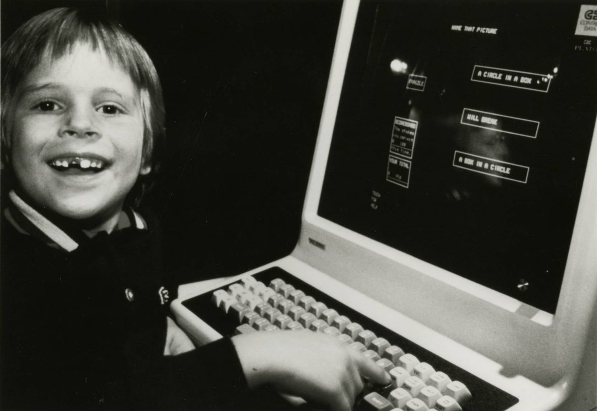 JustCodeCulture's tweet photo. CBI Image o' Day. An iconic picture of smiling boy posing for the camera as he uses Control Data PLATO educational hardware/software system (originating at U of Ill) circa the early 1970s #plato #controldata #timesharing #educationalcomuting #softwarehistory #software @iSchoolUI https://t.co/FmAMbQXdJQ