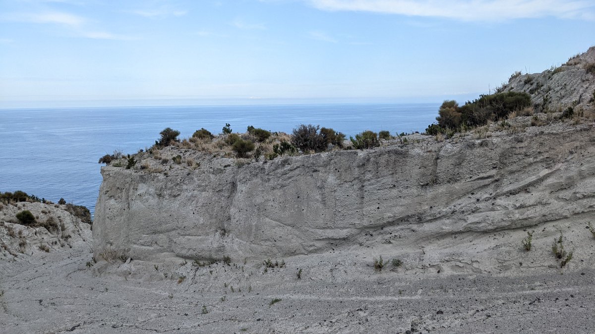 bsburnham's tweet photo. Hung out on the Aeolian Islands last week looking at volcaniclastics with @Liam_Geochem & @john_arcade - the rocks and views did not disappoint. Saw some awesome #seddy structures and even caught a glimpse of #stromboli activity in the distance! 🌋 Much to do with these rocks. https://t.co/bRhBmqMDsl