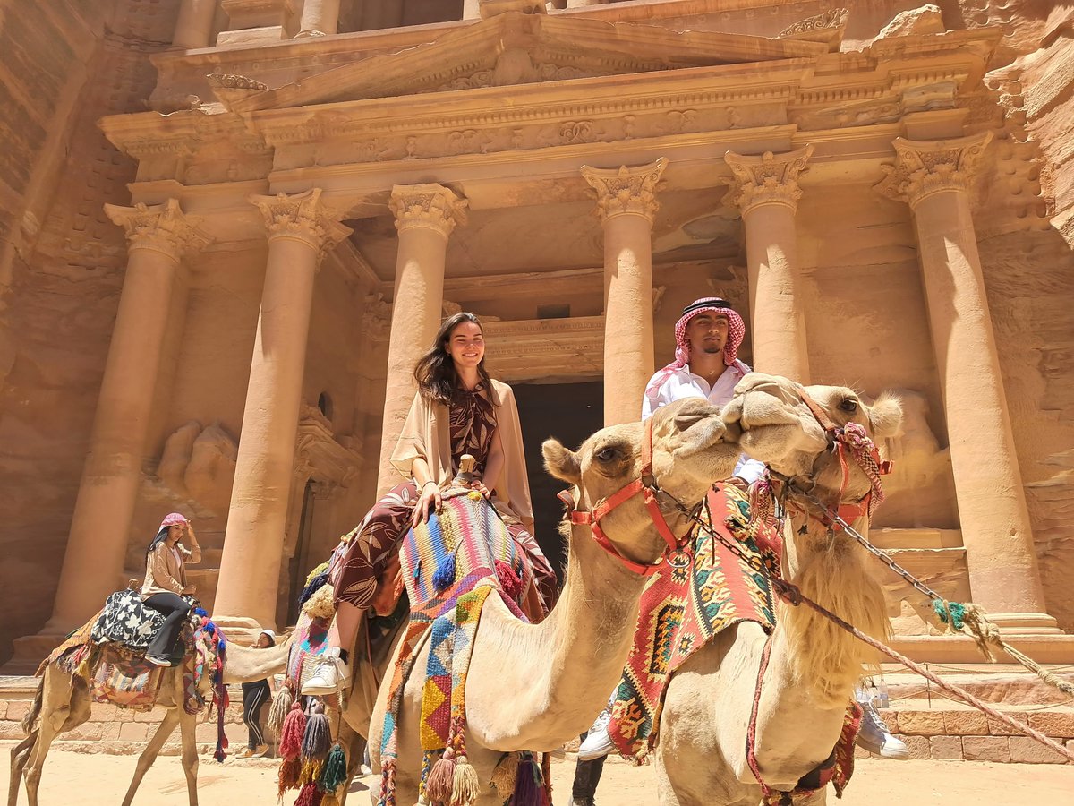 CLSscholarship's tweet photo. #CLSArabic scholars Carolina and Abdulla visit Petra and even get a ride from a couple of camels! Petra is located in present-day Jordan and dates back to fourth century B.C. It is a UNESCO world heritage site and one of the Seven Wonders of the World. @ECAatState #CLS22 https://t.co/fP2QJqpPRo