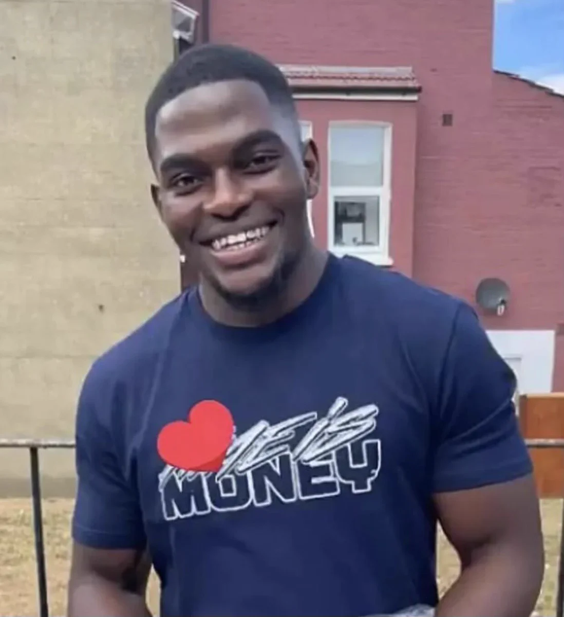 Photo of Chris Kaba, smiling. Black man with short hair in blue tshirt.