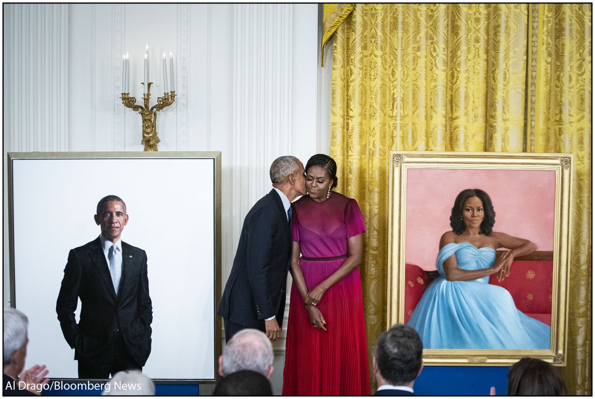 Former President Barack Obama kisses former US First Lady Michelle Obama as their official White House portraits are unveiled in the East Room on Wednesday. The portraits, commissioned by the White House Historical Association, were painted by Robert McCurdy and Sharon Sprung.