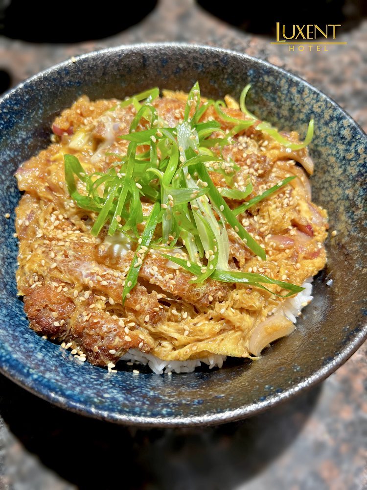 LuxentHotel's tweet photo. Luxent Hotel’s Pork Katsudon is a comforting, belly-warming dish composed of sliced pork cutlets simmered in a dashi-based broth with onion and eggs and served over a bowl of warm rice. 

#LushBarAndLounge #VertigoPoolDeckBar #porkkatsudon https://t.co/wd9GRoj7yn