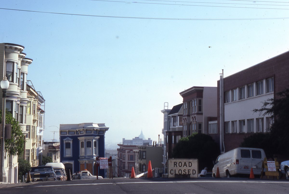 San Francisco Victorian on the move in November 1978. What street is this? There are clues to the location, like City Hall in the right distance. #sanfranciscoarchitecture