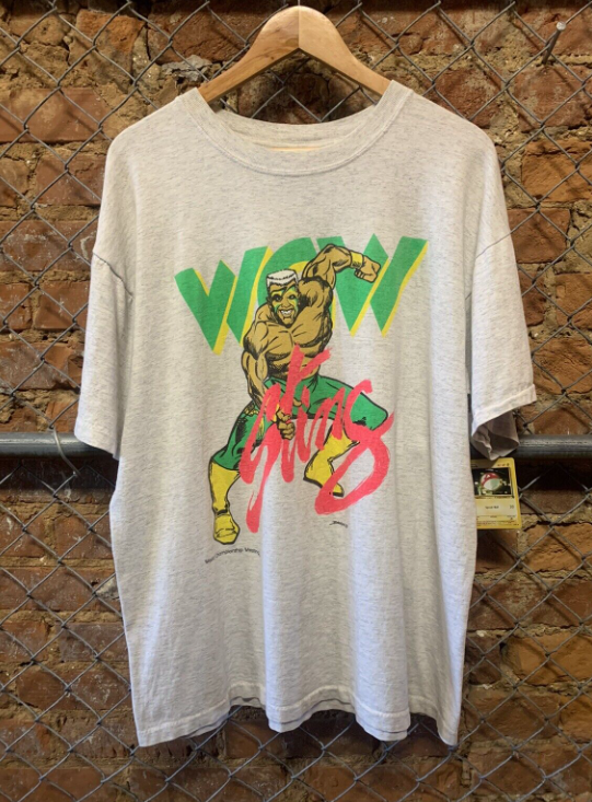 WCWTFPodcast's tweet photo. #WCWWorstMerch @Sting @AEW @AEWonTV
This is by far the most totally tubular, gnarly and radical t-shirt design of Sting grabbing something phallic that I've ever seen. https://t.co/INqdlle7CC