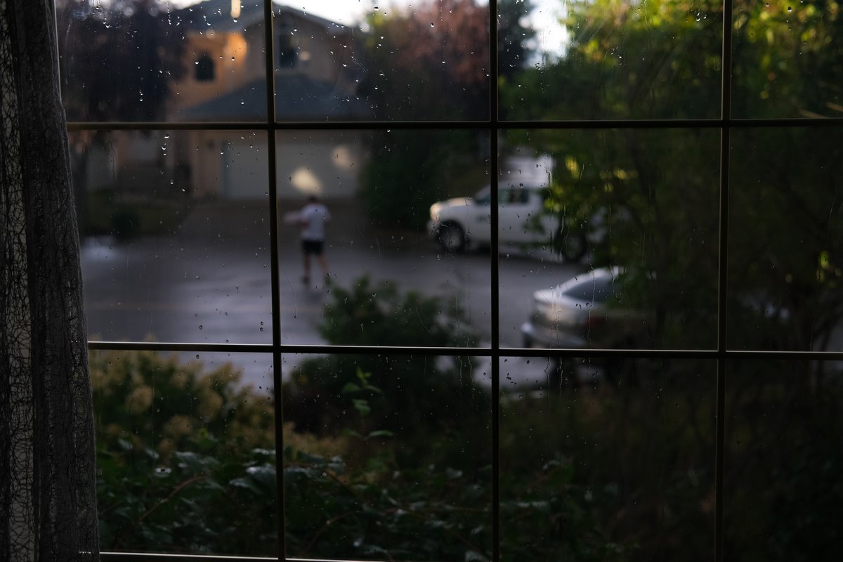 The suburbs. Neighbour bringing home pizza (Franco's) after the rain. 

#yeg #suburbs #edmontonphotography