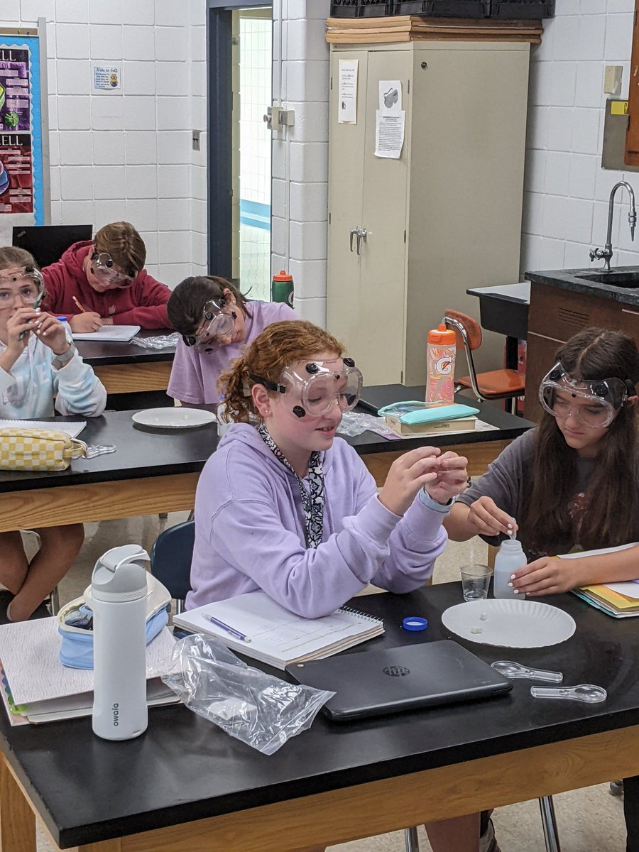 Science students investigating chemical reactions using everyday household items.