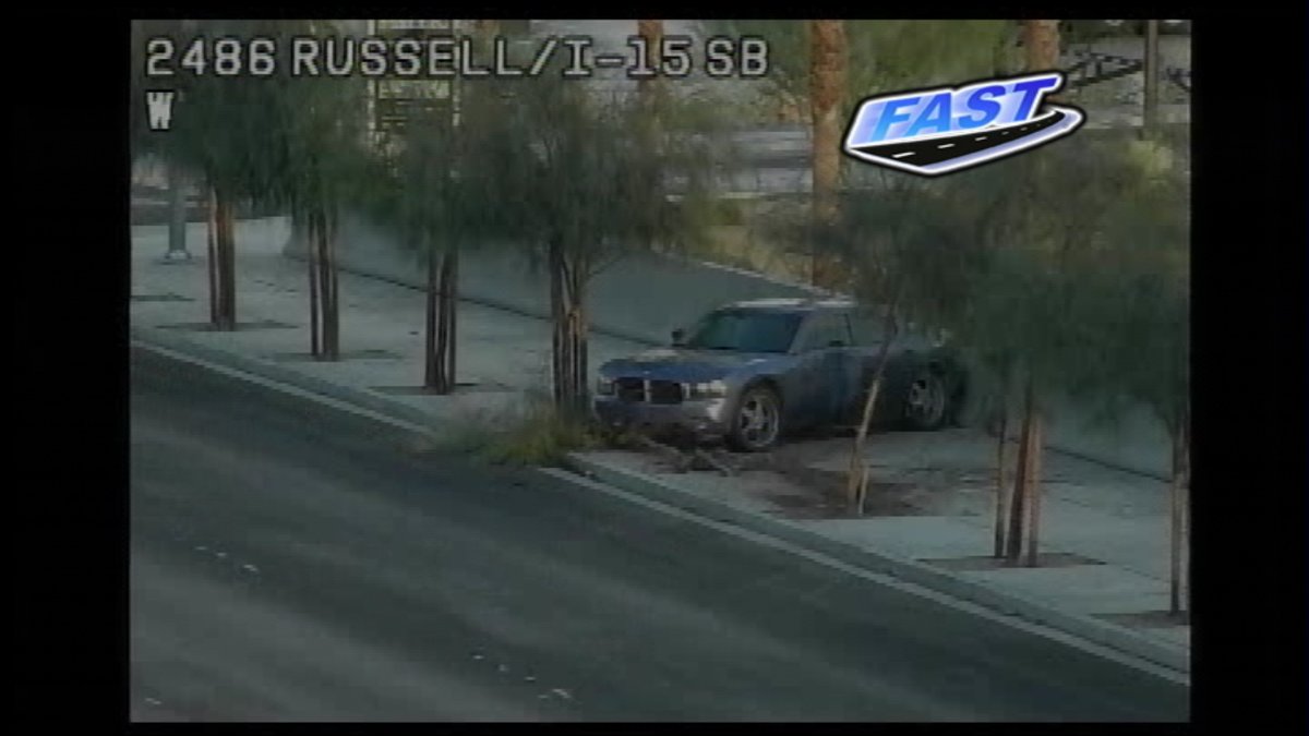 ZoraAsberry's tweet photo. Looks like there's been a crash on Russell Rd. headed WB at I-15 sending a car onto the sidewalk. #ProblemSolverTraffic https://t.co/INXSJX8PvY