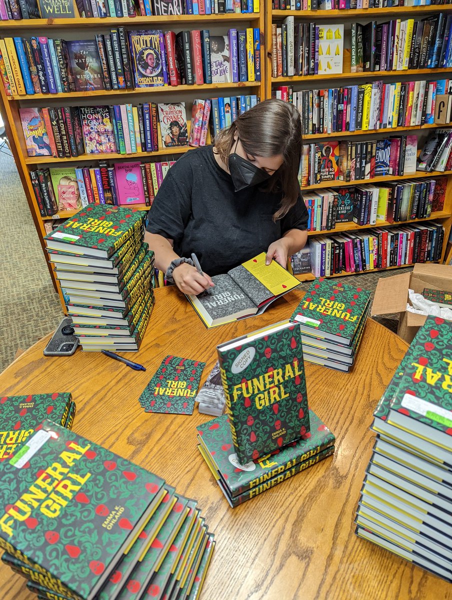 You can still snag a signed copy of Funeral Girl by @ohkemma, seen here, signing books like a pro. Come see her talk about the book this Saturday, Sept. 10th at 7 PM.