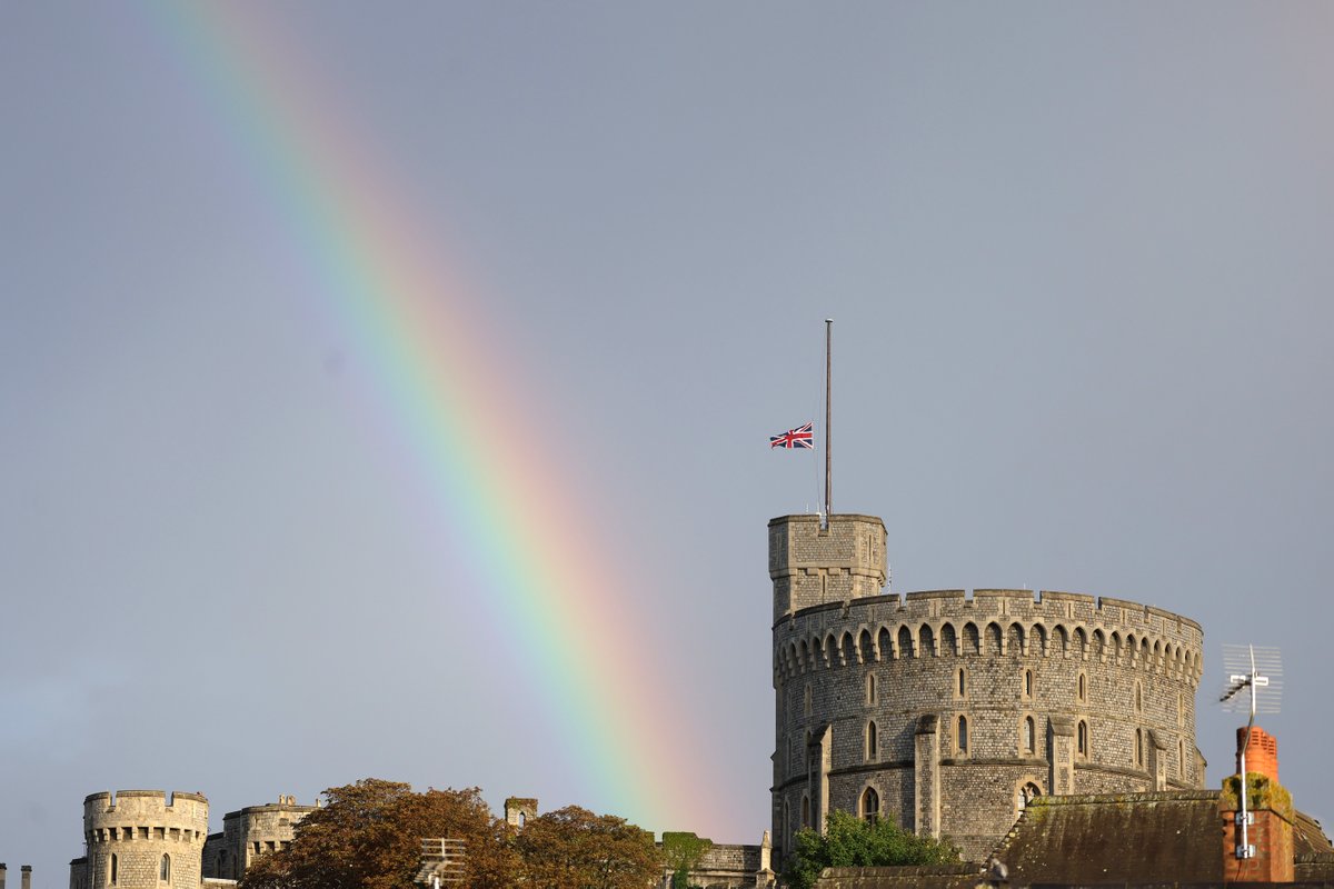 The Union flag is lowered on Windsor Castle as a rainbow covers the sky Thursday afternoon in Windsor, England. (Photo by Chris Jackson/Getty Images)