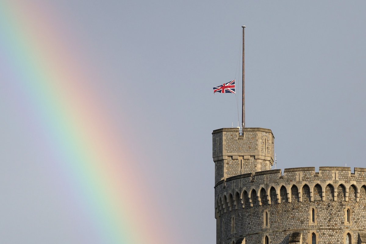 australian's tweet photo. A rainbow appears over Windsor Castle, as the Union flag is lowered to mark the death of Her Majesty, The Queen.⁠
⁠
Picture: Chris Jackson⁠
⁠
#QueenElizabeth https://t.co/bmtFqvU1bW