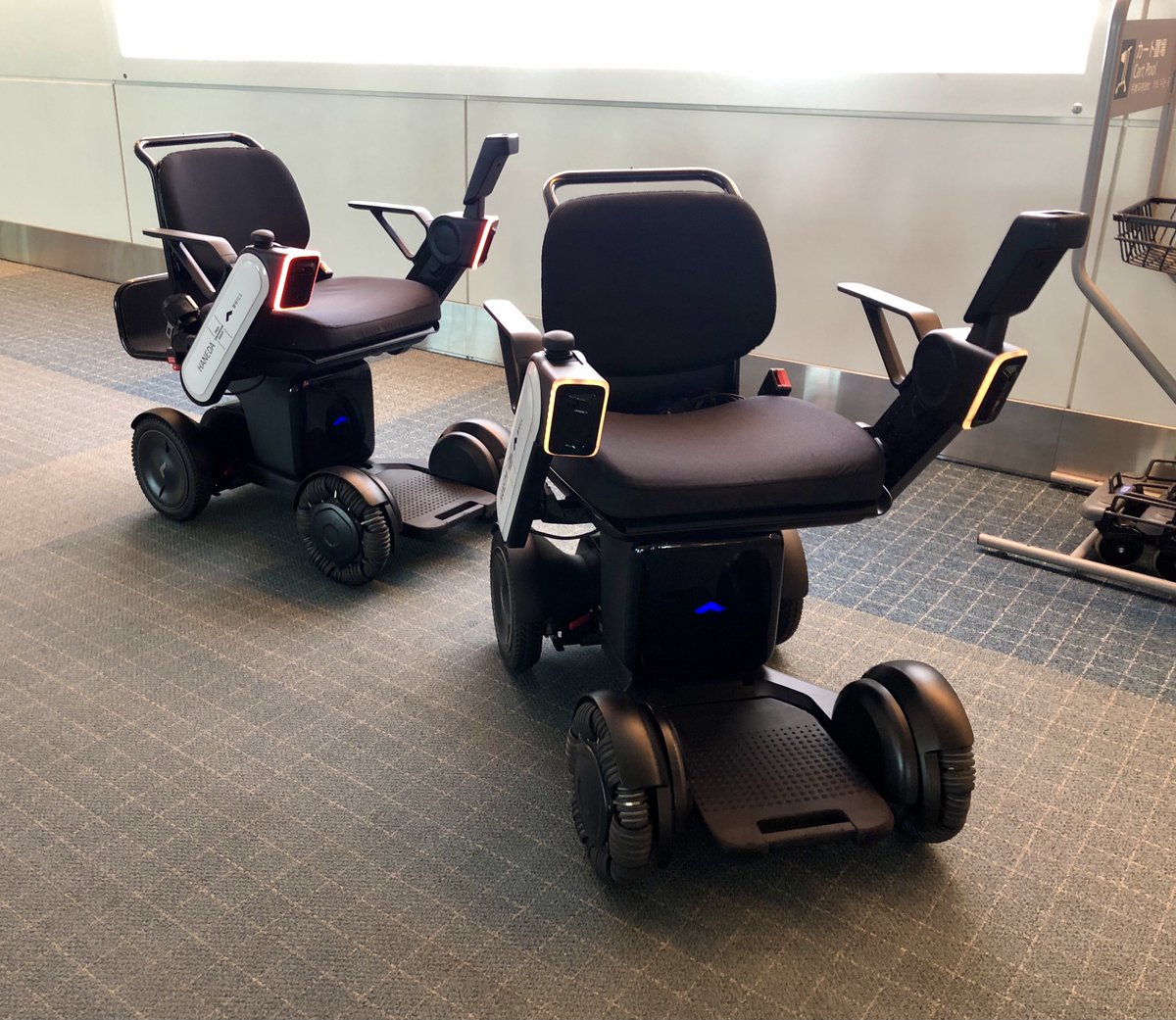 robotopia's tweet image. Very Japan moment at Haneda Airport when two #robot wheelchairs get stuck and keep telling each other, "Excuse me, kindly make way."