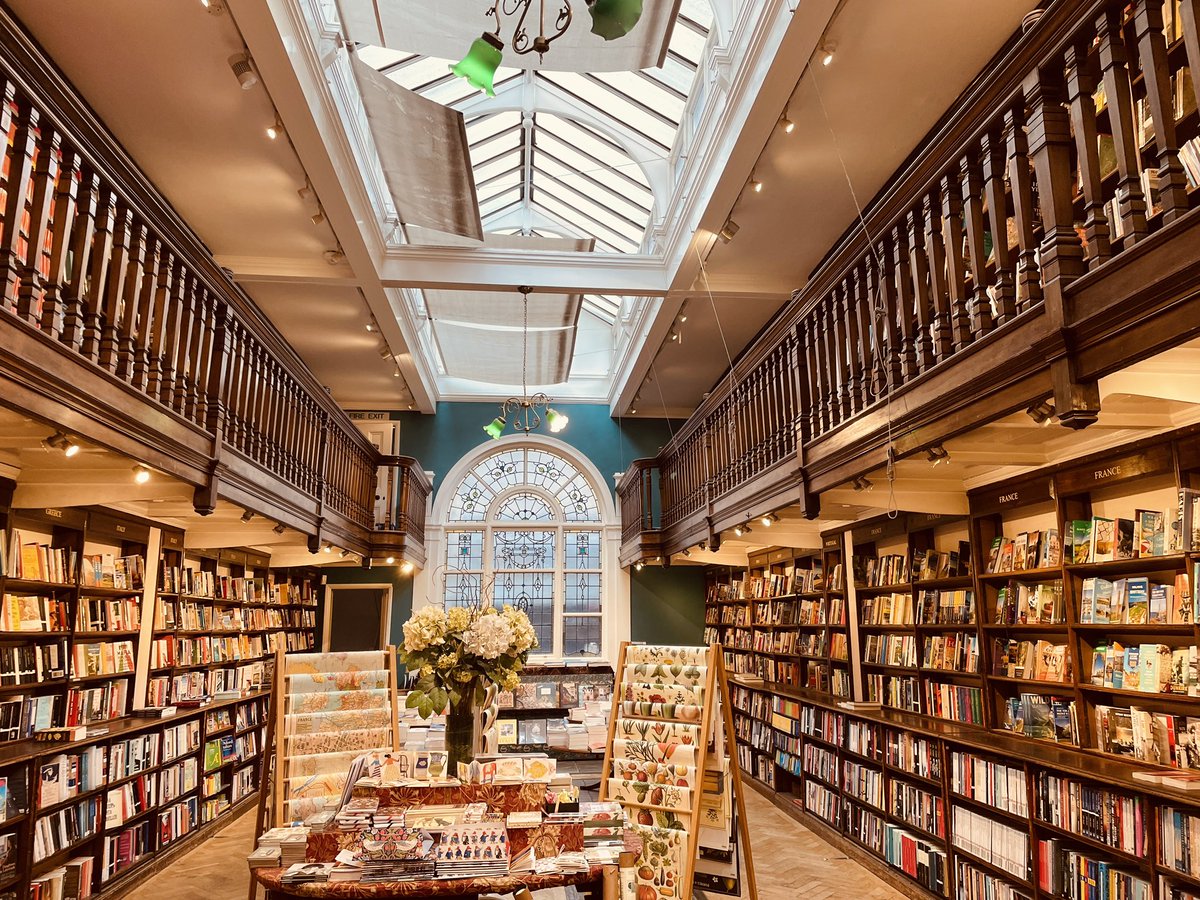 ZahirraD's tweet photo. Feels like your garden variety bookshop when you first step in, but it is very far from it. All that wood and the incredible silence. And those windows! Finally, I love that they recognise Africa is not a country. All the regions of the continent are well-represented 💜 #daunt https://t.co/FalaKKeNCT