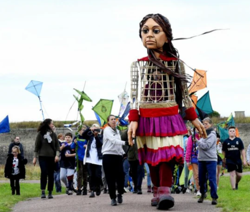 Little Amal is the giant puppet of a 10 year old Syrian refugee girl at the heart of THE WALK.

From 9/14–10/2, Little Amal will explore all five NYC boroughs in partnership <a href="/stannswarehouse/">St. Ann's Warehouse</a>. PlayCo friend Amir Nizar Zuabi is the Artistic Director.

Info: ow.ly/AyaI50KFy6H