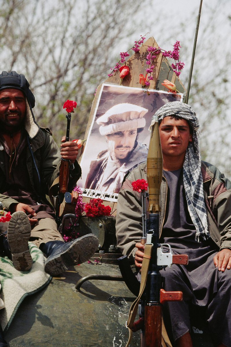 HistoryImageBot's tweet image. Mujahideen display a poster of their leader, Ahmed Shah Massoud (Afghanistan 1992) [1364x2048]