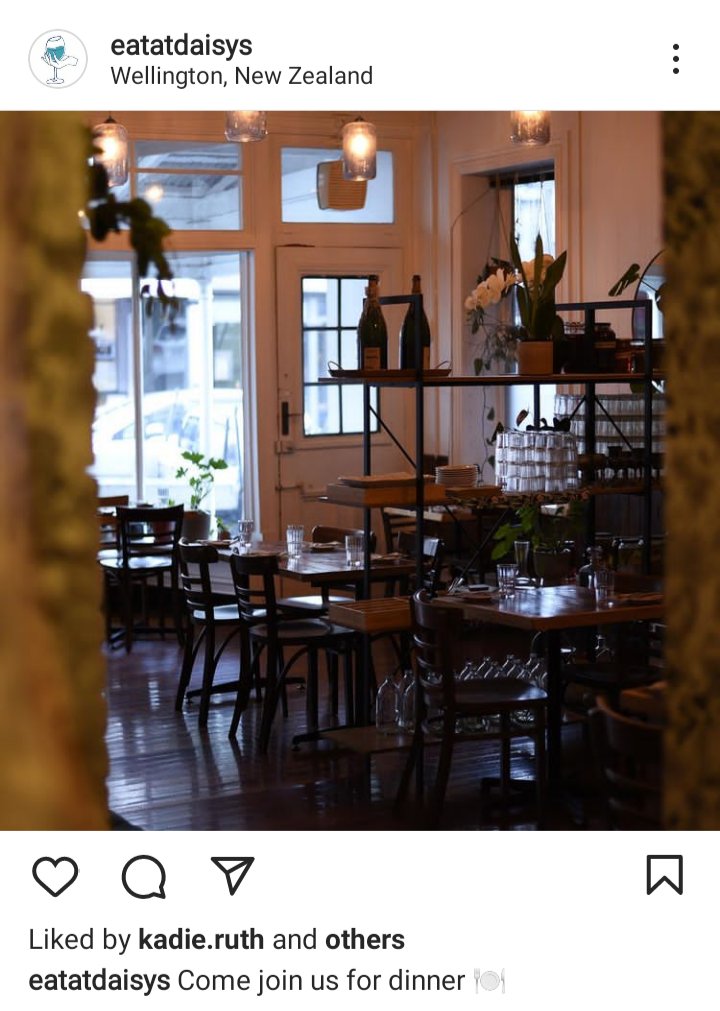 Daisy Restaurant IG: picture of interior of restaurant; bistro tables and dim lighting. Old character. Caption reads: Come join us for dinner! 