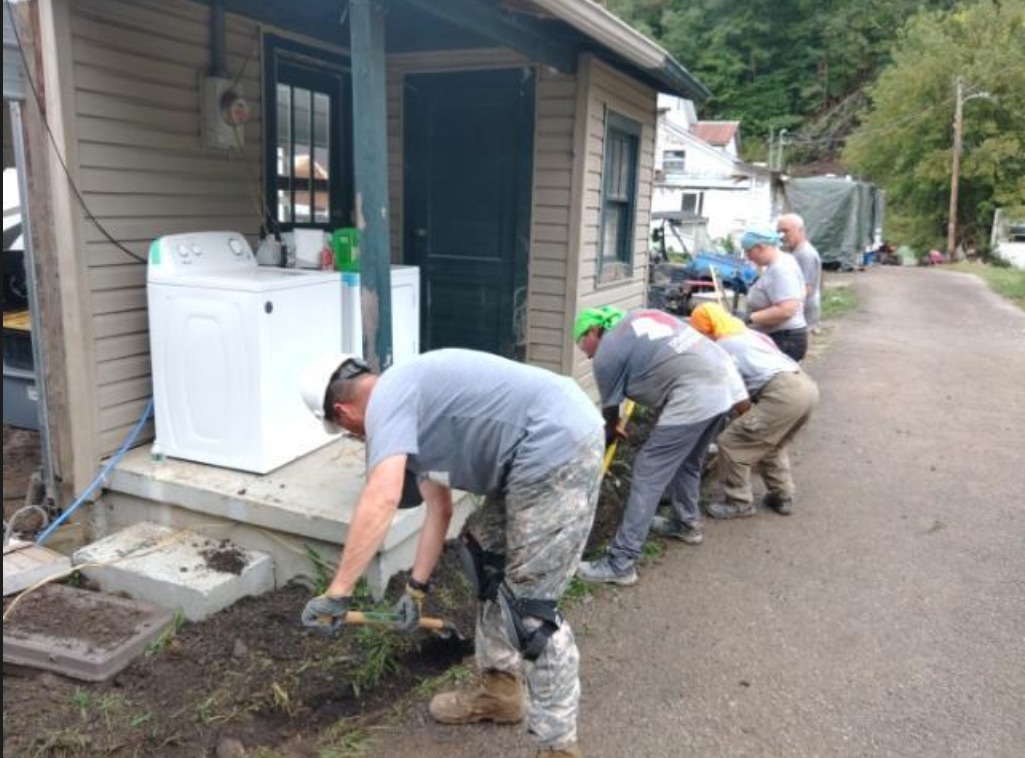 TeamRubicon's tweet photo. The owner rushed out, and grabbed a rototiller to try to save his new home. Without hesitation, Greyshirts ran to get equipment and started digging. They were able to get the ditch dug in time to reroute about 6 inches of water, saving the home from another disaster. https://t.co/JXx5rT4Wwp
