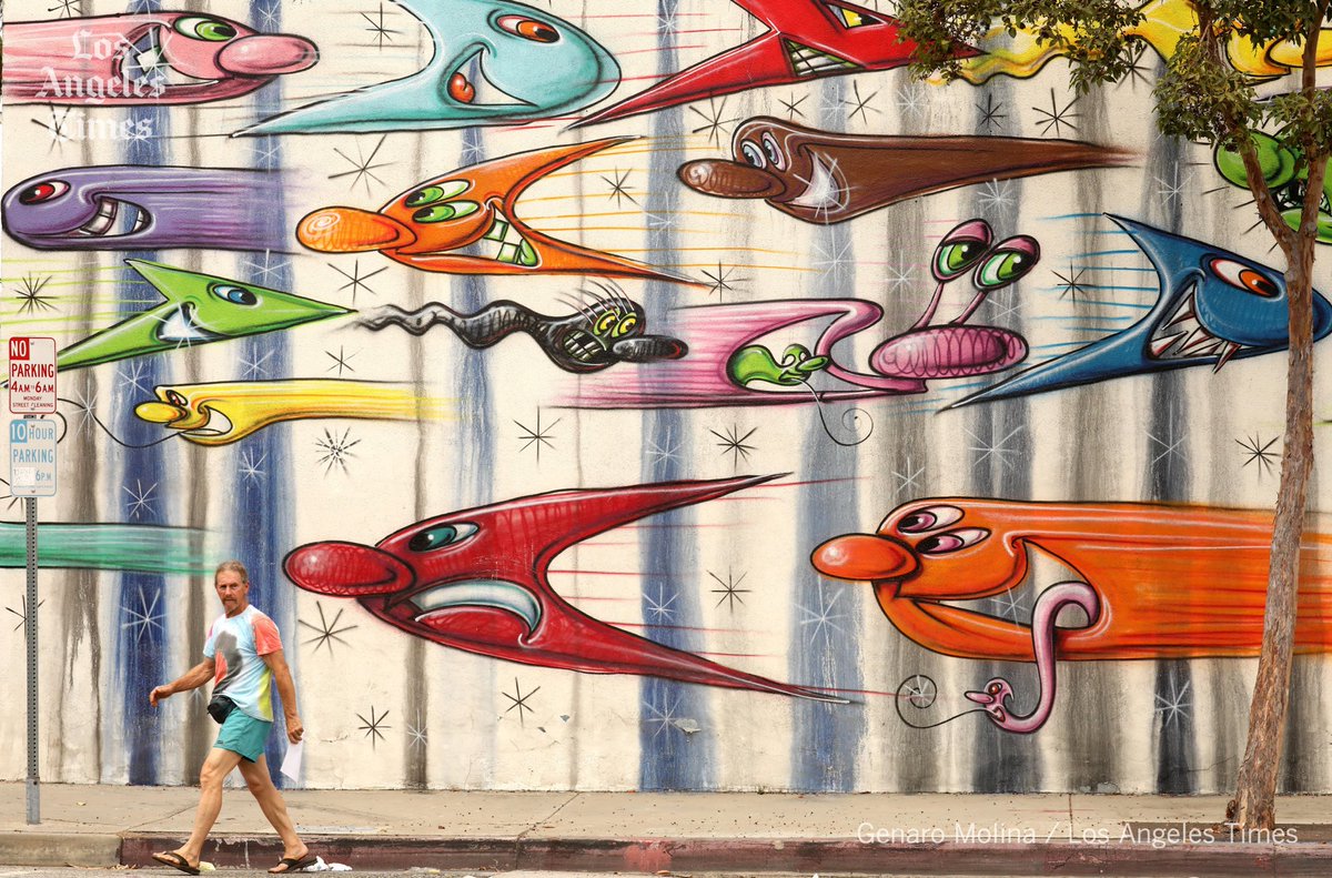 GenaroMolina47's tweet photo. A pedestrian, dressed appropriately for the heatwave, walks past a Kenny Scharf mural in Culver City on September 9, 2022. #heatwave #socal #LA #photography #latimes https://t.co/CGnv7BK9fY