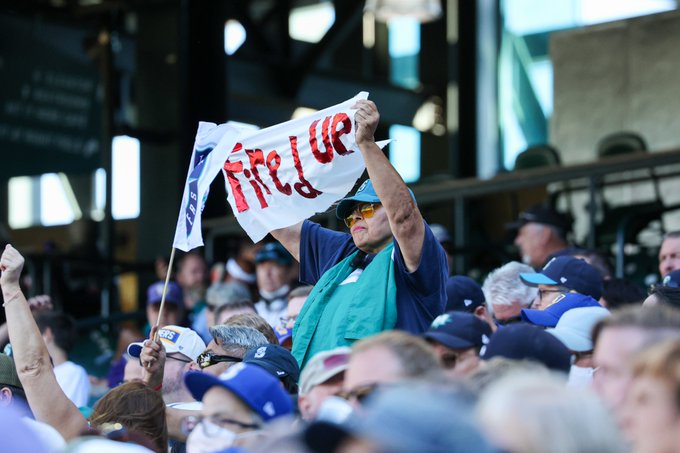 A Mariners fan holds up a sign that says, 