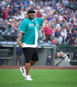 Walter Jones waves to the crowd while taking the field.