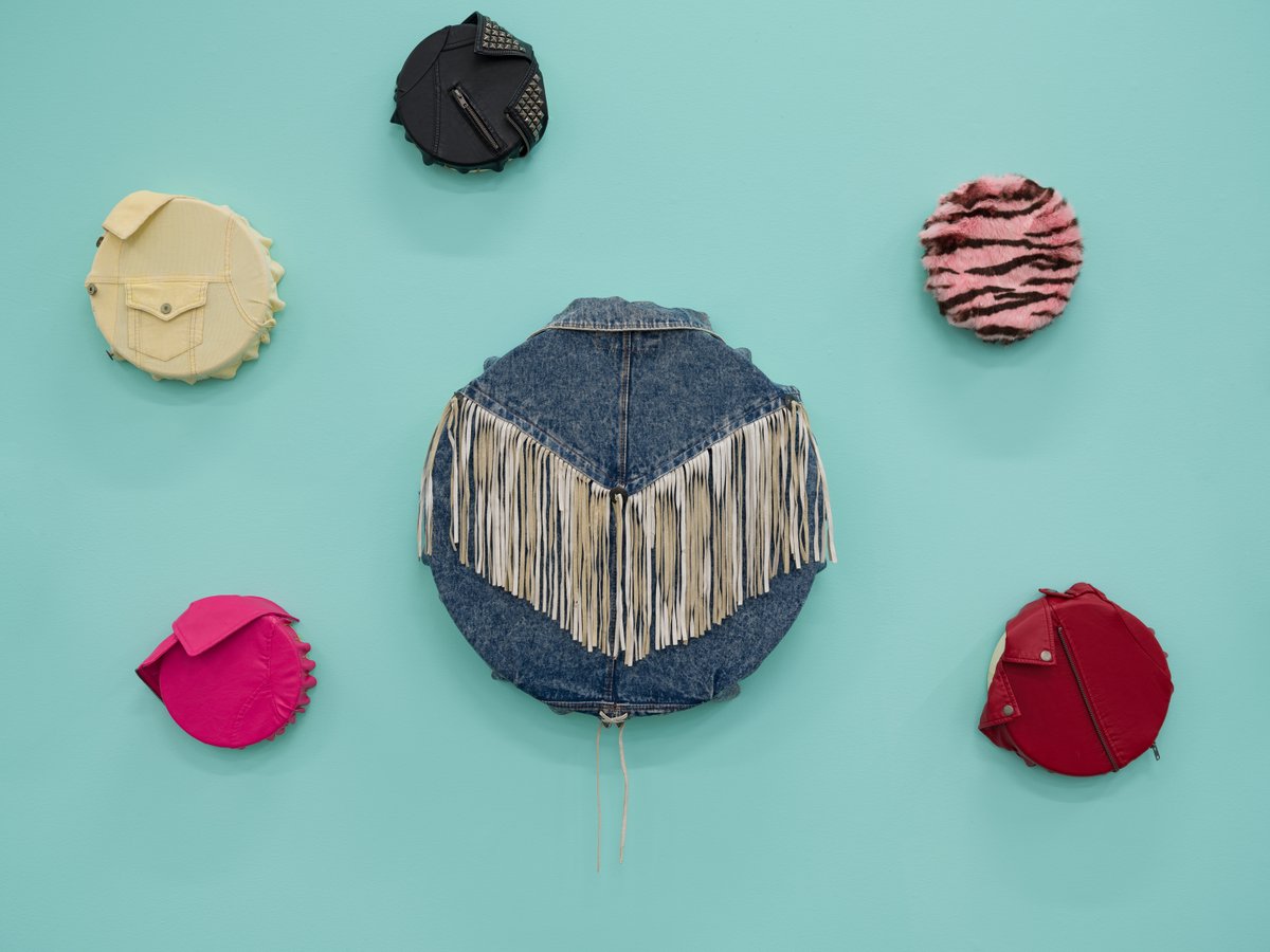 BurrardArts's tweet photo. The stretched drums from #MichelleSound's "Aunties" series pay homage to a community of caretakers, and are a tribute to what Sound calls "classic auntie style." The 17 drums currently on display at BAF feature acid wash denim, leather fringe, dyed fur, and more. https://t.co/oHo8A4qnDL